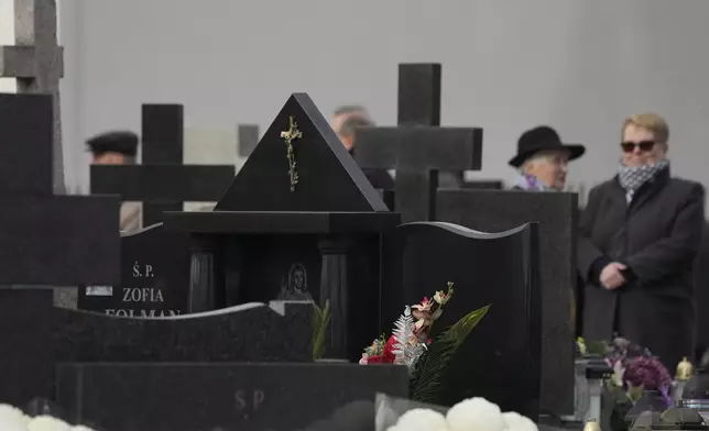 People observe All Saints' Day, a time for reflecting on those who have died, on Friday Nov. 1, 2024, in Zakroczym near Warsaw, Poland. (AP Photo/Czarek Sokolowski)