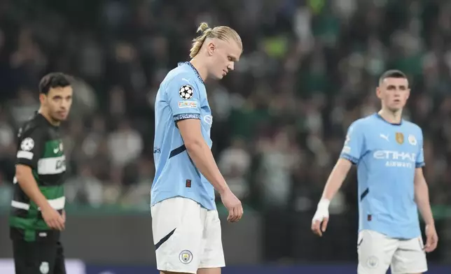 Manchester City's Erling Haaland reacts after missing a penalty kick during the UEFA Champions League opening phase match between Sporting and Manchester City in Lisbon, Portugal, Tuesday, Nov. 5, 2024. (AP Photo/Armando Franca)