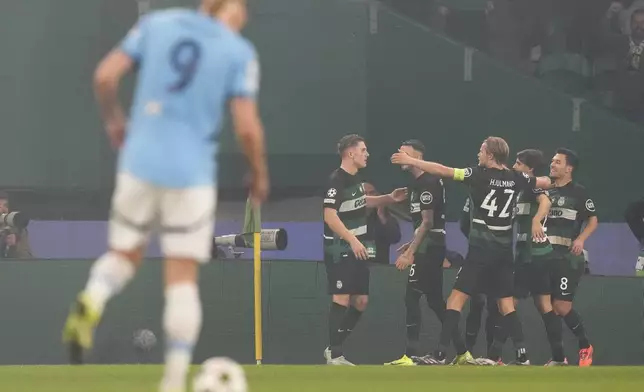 Sporting players celebrate after a goal during the UEFA Champions League opening phase match between Sporting and Manchester City in Lisbon, Portugal, Tuesday, Nov. 5, 2024. (AP Photo/Armando Franca)