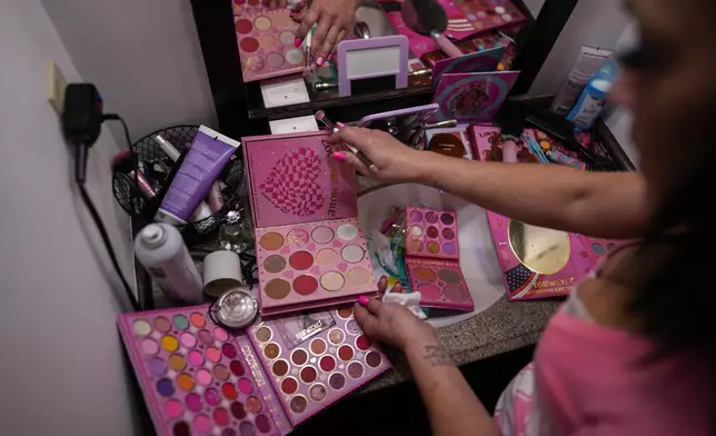 April Youst does her makeup in her West Virginia home, Wednesday, Oct. 9, 2024. (AP Photo/Carolyn Kaster)