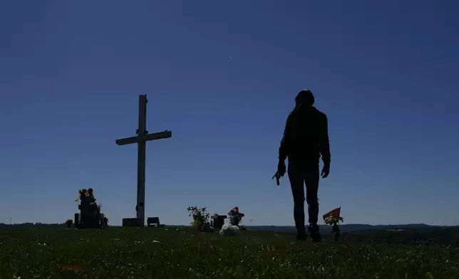 April Youst walks through a cemetery, where she says it is beautiful and quiet, in West Virginia on Wednesday, Oct. 9, 2024. (AP Photo/Carolyn Kaster)