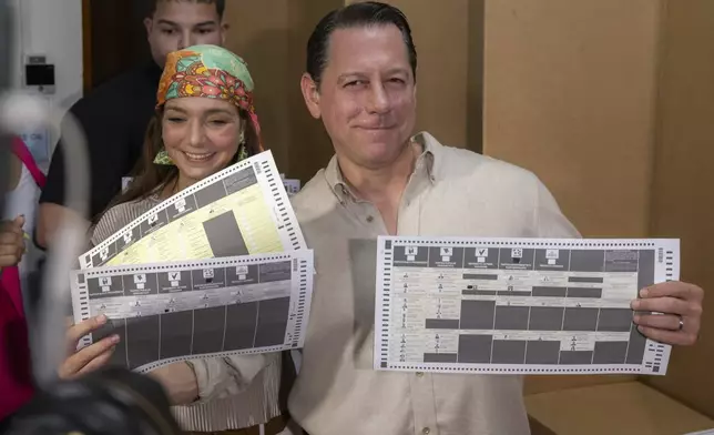 Juan Dalmau, Puerto Rico's Independence Party candidate for Governor, shows his ballots during general elections in San Juan, Puerto Rico, Tuesday, Nov. 5, 2024. (AP Photo/Alejandro Granadillo)