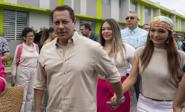 Juan Dalmau, Puerto Rico's Independence Party candidate for Governor, arrives with his family to vote in general elections in San Juan, Puerto Rico, Tuesday, Nov. 5, 2024. (AP Photo/Alejandro Granadillo)