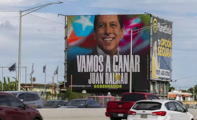 A billboard promoting Puerto Rico’s Independence Party and the Citizen Victory Movement gubernatorial candidate Juan Dalmau towers over a highway, in San Juan, Puerto Rico, Saturday, Nov. 2, 2024.(AP Photo/Alejandro Granadillo)