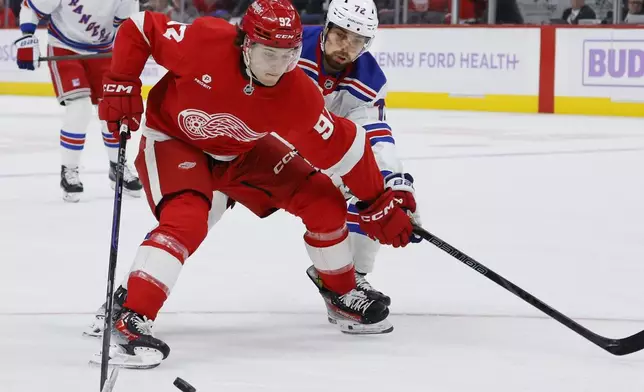 Detroit Red Wings center Marco Kasper (92) drives toward the goal against New York Rangers center Filip Chytil (72) during the first period of an NHL hockey game Saturday, Nov. 9, 2024, in Detroit. (AP Photo/Duane Burleson)