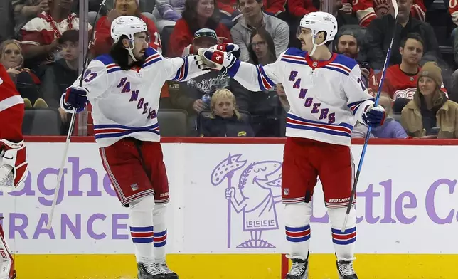 New York Rangers left wing Chris Kreider (20) celebrates after his goal against the Detroit Red Wings with center Mika Zibanejad, left, during the first period of an NHL hockey game Saturday, Nov. 9, 2024, in Detroit. (AP Photo/Duane Burleson)