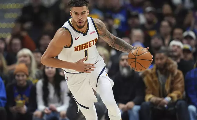 Denver Nuggets forward Michael Porter Jr. collects the ball in the first half of an NBA basketball game against the Toronto Raptors, Monday, Nov. 4, 2024, in Denver. (AP Photo/David Zalubowski)