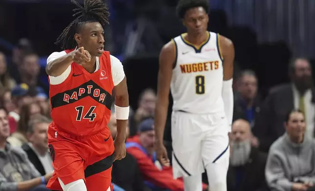 Toronto Raptors guard Ja'Kobe Walter, left, reacts after hitting a 3-point basket over Denver Nuggets forward Peyton Watson in the first half of an NBA basketball game Monday, Nov. 4, 2024, in Denver. (AP Photo/David Zalubowski)