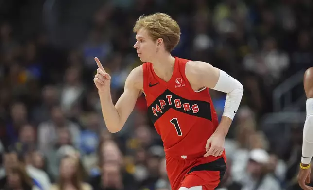 Toronto Raptors guard Gradey Dick gestures after hitting a 3-point basket against the Denver Nuggets in the first half of an NBA basketball game Monday, Nov. 4, 2024, in Denver. (AP Photo/David Zalubowski)