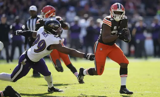 Cleveland Browns running back Nick Chubb (24) gets past Baltimore Ravens linebacker Odafe Oweh (99) as he runs during the first half of an NFL football game in Cleveland, Sunday, Oct. 27, 2024. (AP Photo/Sue Ogrocki)