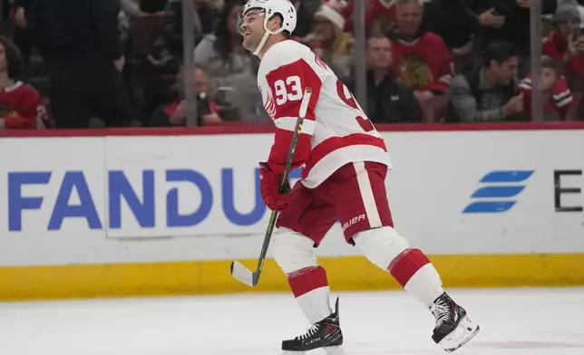 Detroit Red Wings right wing Alex DeBrincat celebrates after scoring on Chicago Blackhawks goaltender Petr Mrazek during the first period of an NHL hockey game Wednesday, Nov. 6, 2024, in Chicago. (AP Photo/Erin Hooley)