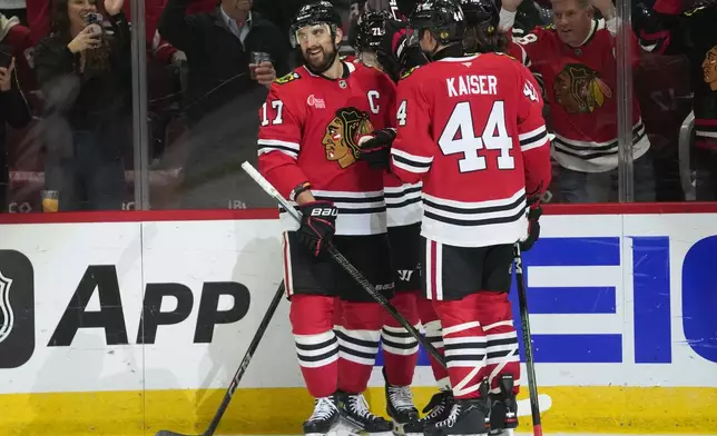 Chicago Blackhawks left wing Nick Foligno, left, celebrates after scoring on Detroit Red Wings goaltender Cam Talbot during the second period of an NHL hockey game Wednesday, Nov. 6, 2024, in Chicago. (AP Photo/Erin Hooley)