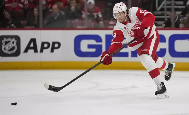 Detroit Red Wings defenseman Moritz Seider clears the puck out of his zone during the second period of an NHL hockey game against the Chicago Blackhawks, Wednesday, Nov. 6, 2024, in Chicago. (AP Photo/Erin Hooley)