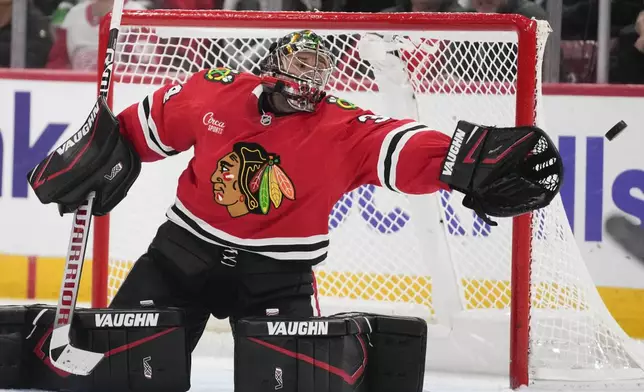 Chicago Blackhawks goaltender Petr Mrazek deflects the puck during the third period of an NHL hockey game that the Detroit Redwings won 4-1 Wednesday, Nov. 6, 2024, in Chicago. (AP Photo/Erin Hooley)