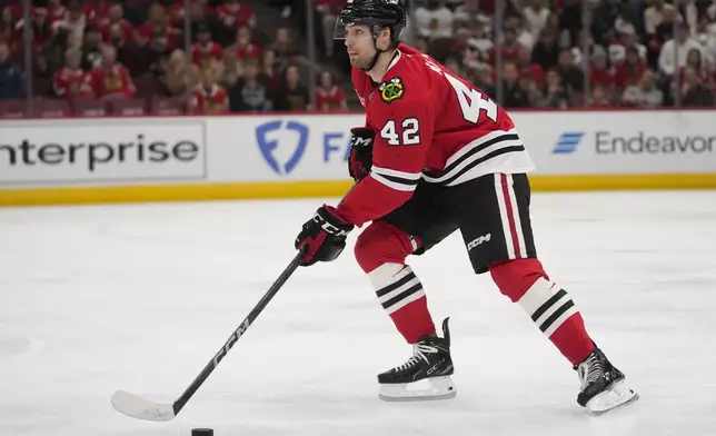 Chicago Blackhawks defenseman Nolan Allan handles the puck during the third period of an NHL hockey game that the Detroit Redwings won 4-1 Wednesday, Nov. 6, 2024, in Chicago. (AP Photo/Erin Hooley)