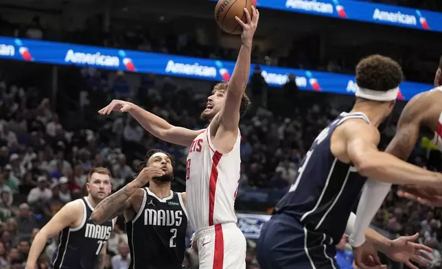 Houston Rockets center Alperen Sengun (28) shoots as Dallas Mavericks' Dereck Lively II (2) defends in the first half of an NBA basketball game in Dallas, Thursday, Oct. 31, 2024. (AP Photo/Tony Gutierrez)