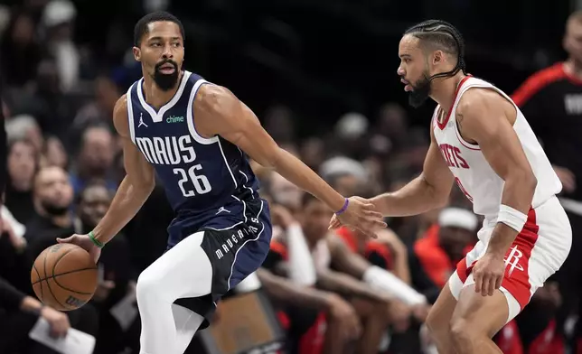 Dallas Mavericks guard Spencer Dinwiddie (26) works against Houston Rockets forward Dillon Brooks (9) in the first half of an NBA basketball game in Dallas, Thursday, Oct. 31, 2024. (AP Photo/Tony Gutierrez)