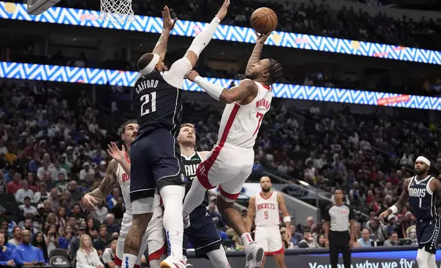 Houston Rockets forward Cam Whitmore (7) shoots over Dallas Mavericks' Daniel Gafford (21) in the first half of an NBA basketball game in Dallas, Thursday, Oct. 31, 2024. (AP Photo/Tony Gutierrez)