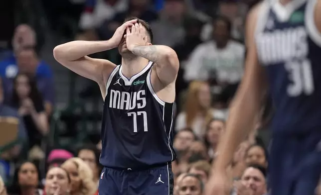 Dallas Mavericks guard Luka Doncic (77) covers his face with his hands taking a shot in the first half of an NBA basketball game against the Houston Rockets in Dallas, Thursday, Oct. 31, 2024. (AP Photo/Tony Gutierrez)