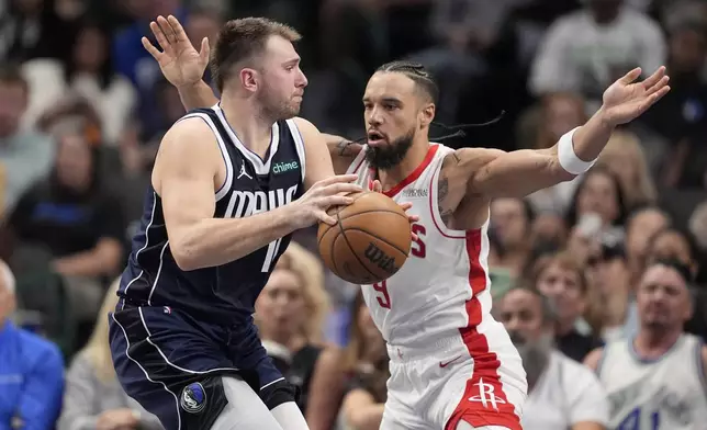 Dallas Mavericks guard Luka Doncic, left, works against Houston Rockets forward Dillon Brooks (9) for a shot attempt in the first half of an NBA basketball game in Dallas, Thursday, Oct. 31, 2024. (AP Photo/Tony Gutierrez)