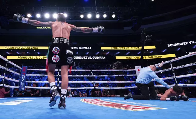 Jesse Rodriguez, left, reacts to dropping Padro Guevara, right, during the third round of a WBC World and Ring Magazine Super-Flyweight titles bout Saturday, Nov. 9, 2024, in Philadelphia. Jesse Rodriguez retains his title with a third round TKO. (AP Photo/Chris Szagola)