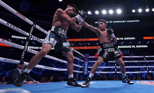 Jesse Rodriguez, right, throws a punch against Padro Guevara, left, during the third round of a WBC World and Ring Magazine Super-Flyweight titles bout Saturday, Nov. 9, 2024, in Philadelphia. Jesse Rodriguez retains his title with a third round TKO. (AP Photo/Chris Szagola)