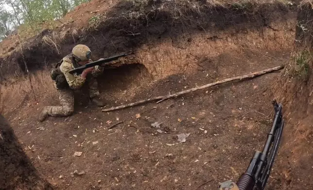 In this photo taken from a bodycam video released by Russian Defense Ministry press service on Thursday, Nov. 7, 2024, a Russian servicemen takes part in a combat training for assault units at an undisclosed location in Ukraine. (Russian Defense Ministry Press Service via AP)