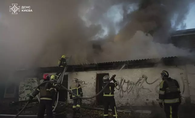 In this photo provided by the Ukrainian Emergency Service on Thursday, Nov. 7, 2024, rescuers put out a fire resulted from Russian drone attack in Kyiv, Ukraine. (Ukrainian Emergency Service via AP)