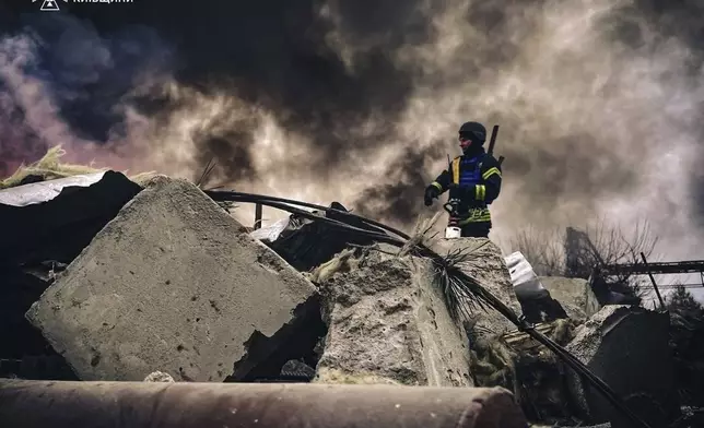 In this photo provided by the Ukrainian Emergency Service on Nov. 13, 2024, rescue workers clear the rubble of a building destroyed by a Russian strike in Brovary, outside Kyiv, Ukraine. (Ukrainian Emergency Service via AP)