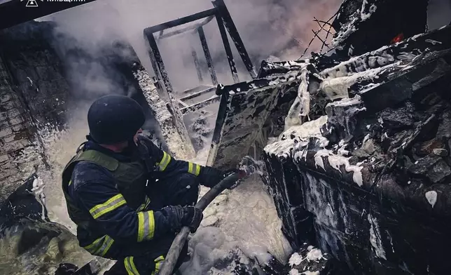 In this photo provided by the Ukrainian Emergency Service on Nov. 13, 2024, rescue workers extinguish a fire of a building destroyed by a Russian strike in Brovary, outside Kyiv, Ukraine. (Ukrainian Emergency Service via AP)