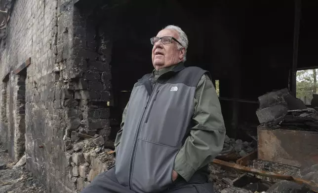 U.S. philanthropist Howard G. Buffett watches the damage after Russian missile attack in Kharkiv region, Ukraine, Monday, Oct. 28, 2024. (AP Photo/Efrem Lukatsky)