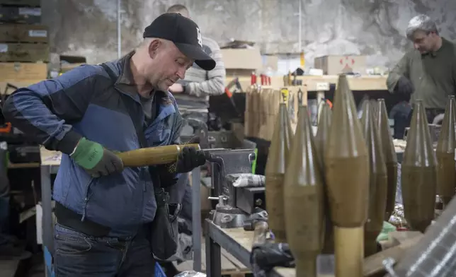 A worker prepares warheads for attack drones in a workshop of Ukraine's drone battalion "Achilles" in Kharkiv region, Ukraine, Sunday, Oct. 27, 2024. (AP Photo/Efrem Lukatsky)