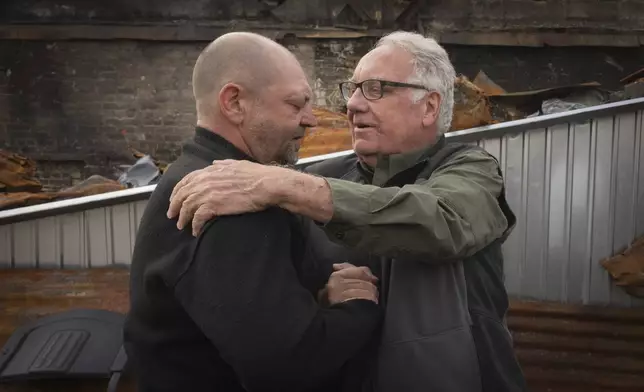 U.S. philanthropist Howard G. Buffett supports a local resident who lost his son in a Russian missile attack in Kharkiv region, Ukraine, Monday, Oct. 28, 2024. (AP Photo/Efrem Lukatsky)