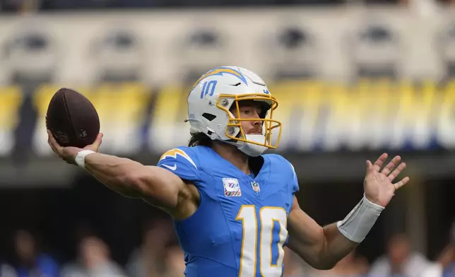 Los Angeles Chargers quarterback Justin Herbert (10) passes in the first half of an NFL football game against the New Orleans Saints in Inglewood, Calif., Sunday, Oct. 27, 2024. (AP Photo/Mark J. Terrill)