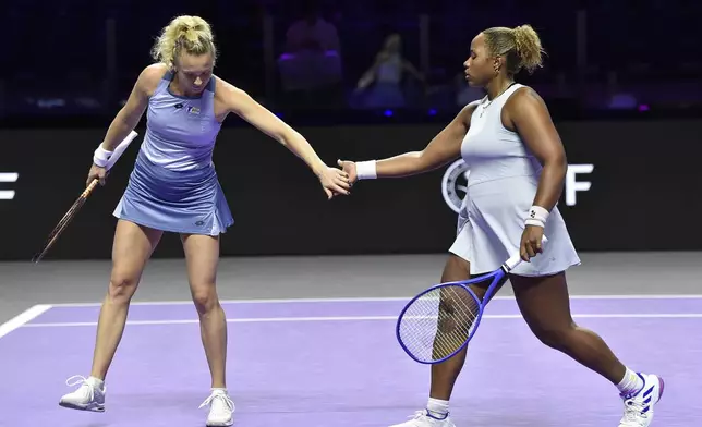 Katerina Siniakova, left, of the Czech Republic, greets Taylor Townsend of the United States, right, during their women's doubles match against Taiwan's Chan Hao-ching and Russia's Veronika Kudermetova in Riyadh, Saudi Arabia, Friday, Nov. 8, 2024. (AP Photo)