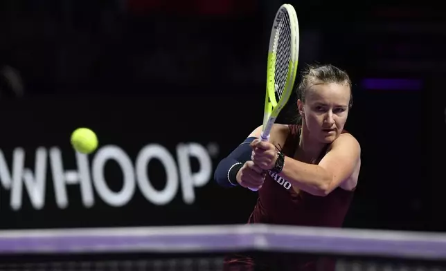 Czech Republic's Barbora Krejcikova, in action with China's Qinwen Zheng during women's singles semi final match at King Saud University Indoor Arena, in Riyadh, Saudi Arabia, Friday, Nov. 8, 2024. (AP Photo)