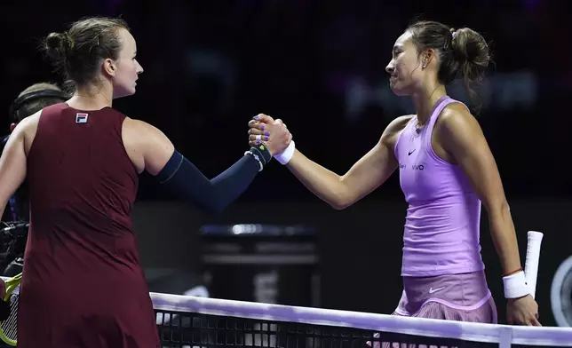 Czech Republic's Barbora Krejcikova, left, shakes hands with winner China's Qinwen Zheng after their women's singles semifinal match at King Saud University Indoor Arena, in Riyadh, Saudi Arabia, Friday, Nov. 8, 2024. (AP Photo)