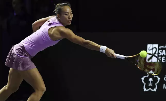 China's Qinwen Zheng returns the ball during her women's singles semifinal match against Czech Republic's Barbora Krejcikova at King Saud University Indoor Arena, in Riyadh, Saudi Arabia, Friday, Nov. 8, 2024. (AP Photo)