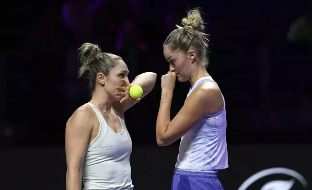 Canada's Gabriela Dabrowski, left, talks to New Zealand's Erin Routliffe during their match against Taylor Townsend of the U.S. and Katerina Siniakova of the Czech Republic in the women's doubles final of the WTA finals at King Saud University Indoor Arena, in Riyadh, Saudi Arabia, Saturday, Nov. 9, 2024. (AP Photo)