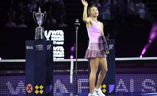 China's Qinwen Zheng waves as she holds her trophy after losing against Coco Gauff of the U.S. in their women's singles final match of the WTA finals at the King Saud University Indoor Arena, in Riyadh, Saudi Arabia, Saturday, Nov. 9, 2024. (AP Photo)