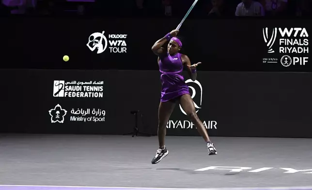 Coco Gauff of the U.S. plays a shot against China's Qinwen Zheng during their women's singles final match of the WTA finals at the King Saud University Indoor Arena, in Riyadh, Saudi Arabia, Saturday, Nov. 9, 2024. (AP Photo)