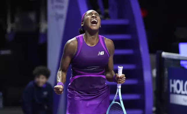 Coco Gauff of the U.S. reacts after winning against China's Qinwen Zheng in their women's singles final match of the WTA finals at the King Saud University Indoor Arena, in Riyadh, Saudi Arabia, Saturday, Nov. 9, 2024. (AP Photo)