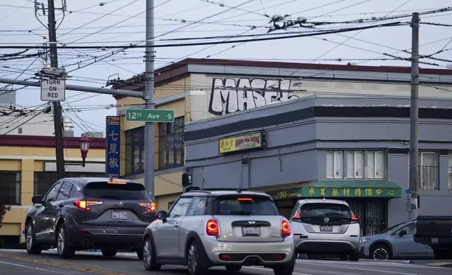 Drivers move through the area where multiple people were stabbed earlier Friday, Nov. 8, 2024, in the Chinatown-International District in Seattle. (AP Photo/Lindsey Wasson)