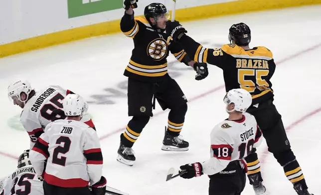 Boston Bruins' Brad Marchand (63) celebrates his goal on Ottawa Senators' Linus Ullmark (35) with teammate Justin Brazeau (55) during the second period of an NHL hockey game, Saturday, Nov. 9, 2024, in Boston. (AP Photo/Michael Dwyer)