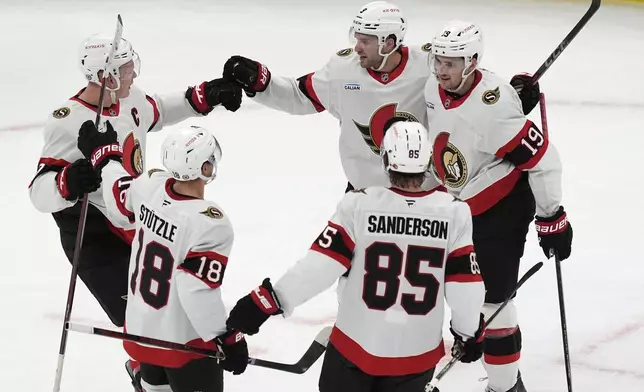 Ottawa Senators' Josh Norris (9) celebrates his goal with Brady Tkachuk (7), Tim Stützle (18), Jake Sanderson (85) and Drake Batherson (19) during the first period of an NHL hockey game against the Boston Bruins, Saturday, Nov. 9, 2024, in Boston. (AP Photo/Michael Dwyer)