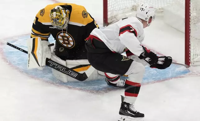 Boston Bruins' Jeremy Swayman (1) blocks a shot by Ottawa Senators' Brady Tkachuk (7) during the second period of an NHL hockey game, Saturday, Nov. 9, 2024, in Boston. (AP Photo/Michael Dwyer)