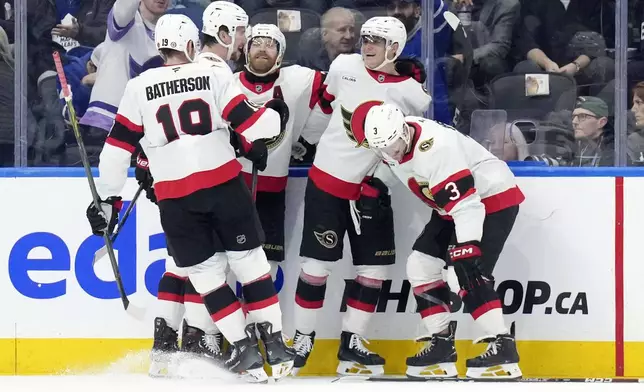 Ottawa Senators' Tim Stutzle, second right, celebrates with teammates after scoring against the Toronto Maple Leafs during the second period of an NHL hockey game in Toronto, Tuesday, Nov. 12, 2024. (Chris Young/The Canadian Press via AP)