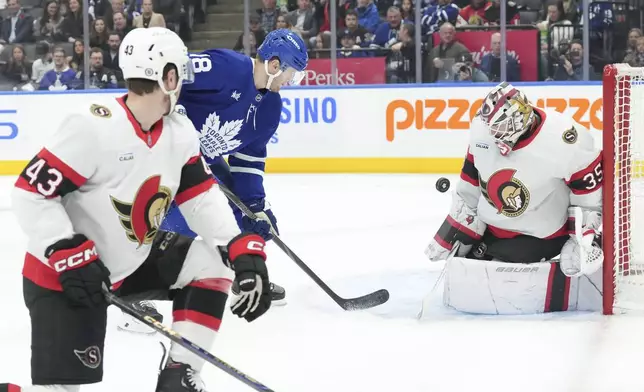 Ottawa Senators goaltender Linus Ullmark makes a stop in front of Toronto Maple Leafs' Steven Lorentz during the second period of an NHL hockey game in Toronto, Tuesday, Nov. 12, 2024. (Chris Young/The Canadian Press via AP)