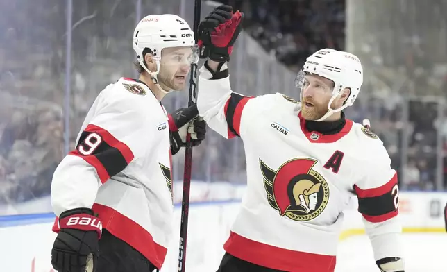 Ottawa Senators' Josh Norris, left, celebrates with Claude Giroux after scoring against the Toronto Maple Leafs during the first period of an NHL hockey game in Toronto, Tuesday, Nov. 12, 2024. (Chris Young/The Canadian Press via AP)