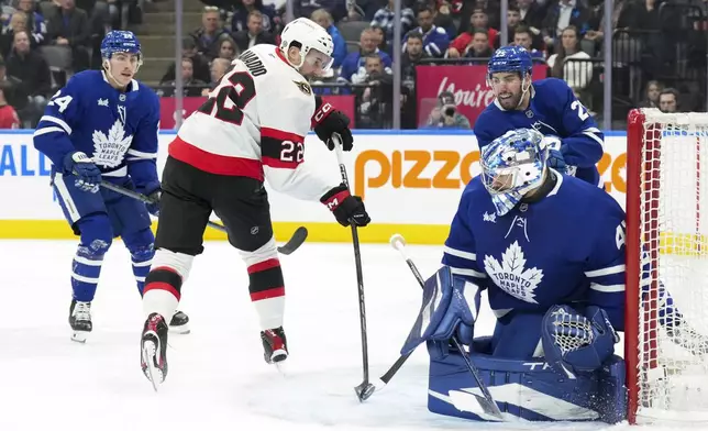 Ottawa Senators' Michael Amadio (22) shoots on Toronto Maple Leafs goaltender Anthony Stolarz, front right, during the first period of an NHL hockey game in Toronto, Tuesday, Nov. 12, 2024. (Chris Young/The Canadian Press via AP)